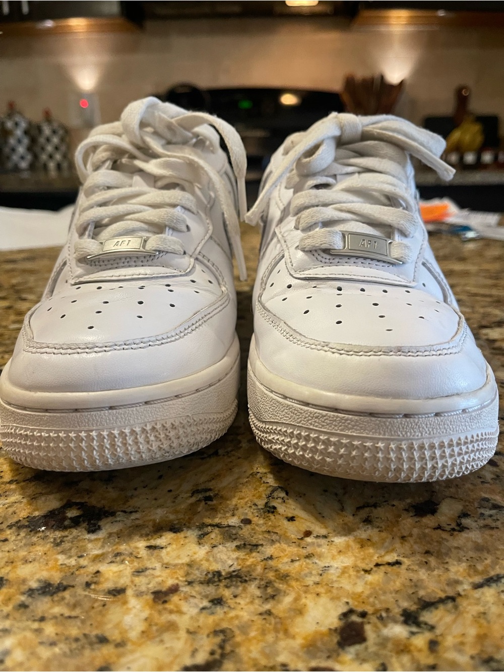 Woman’s white leather Nikes size 7.